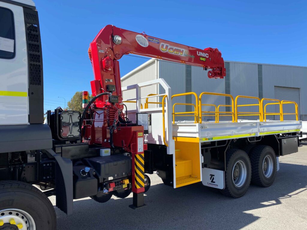 Heavy-duty truck-mounted HIAB crane fitted to a flat tray truck in Perth for service in the Western Australian mining industry.